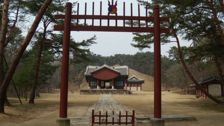 숲에 둘러싸인 조선 왕릉의 정자각과 뒤편 봉분 전경
