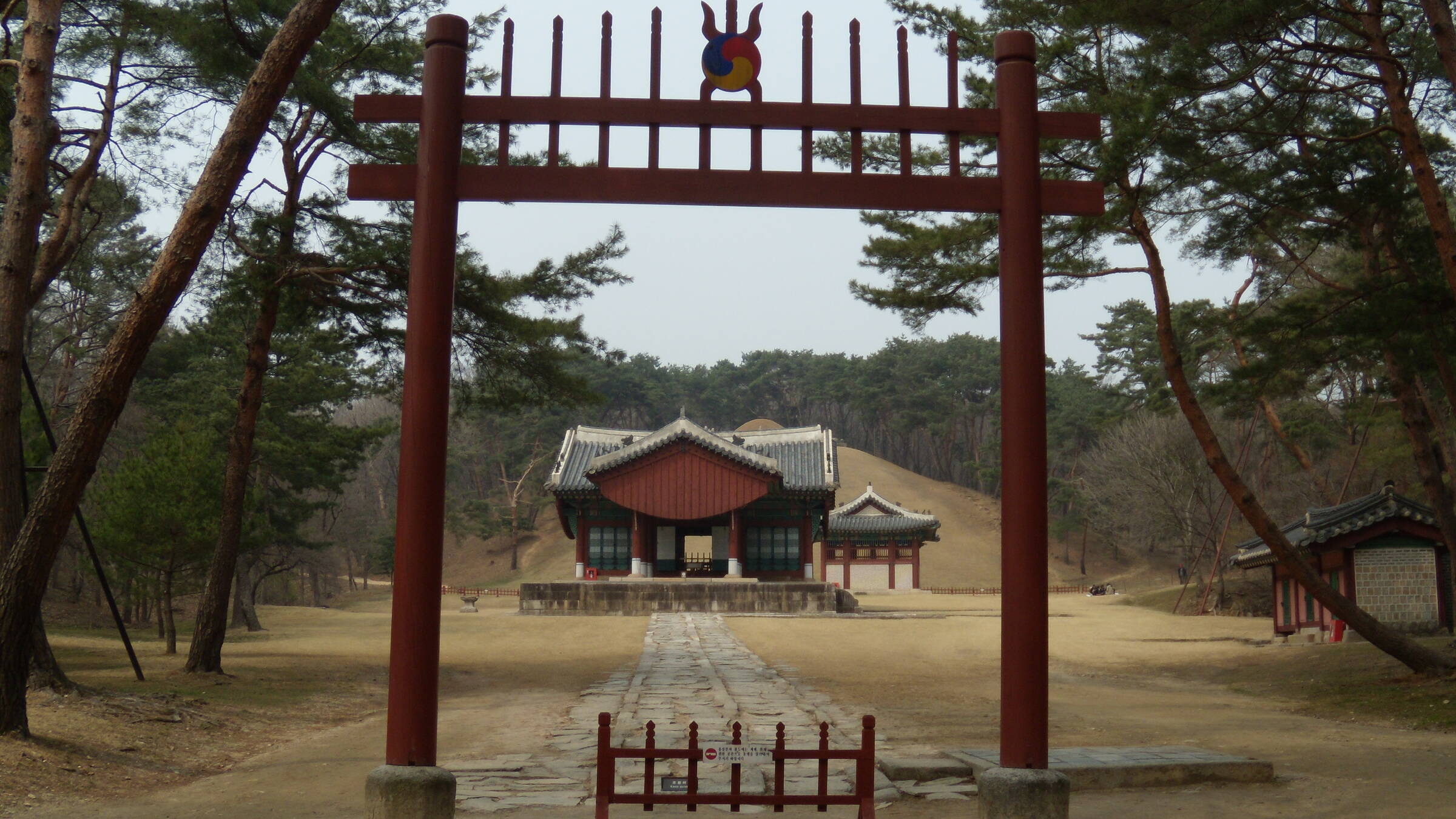 숲에 둘러싸인 조선 왕릉의 정자각과 뒤편 봉분 전경